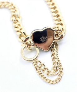 Gold chain necklace with heart pendant.