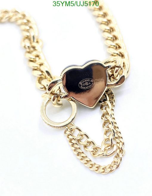 Gold chain necklace with heart pendant.