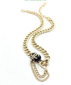 Gold chain necklace with pendant on white background.