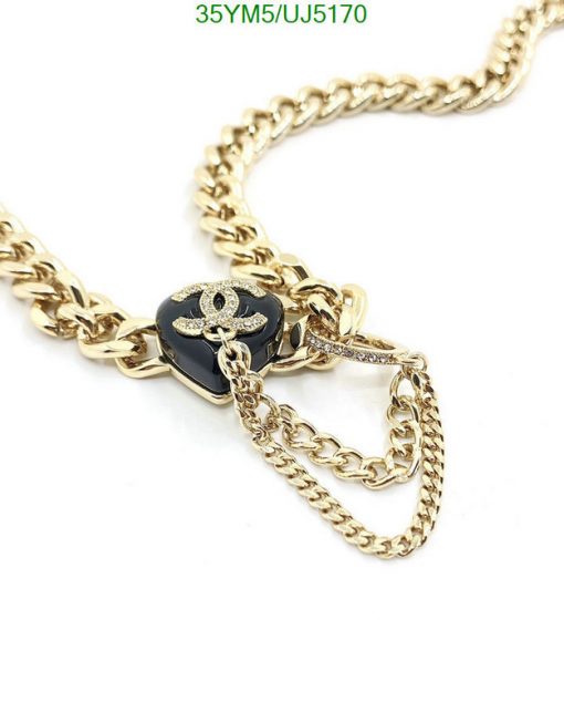 Gold chain necklace with black pendant and anchor detail.