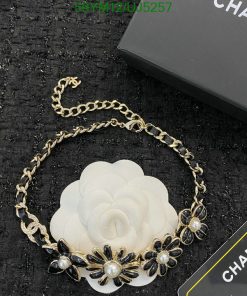 Designer floral necklace on textured background.