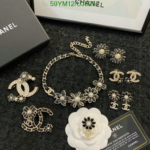 Chanel jewelry collection with flowers and logo on display.