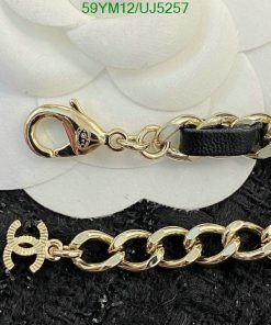 Gold chain with clasp and leather detail.