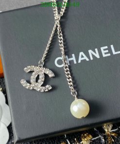 Designer logo necklace with pearl on branded box.