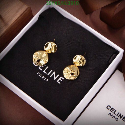 Gold designer earrings in branded box.