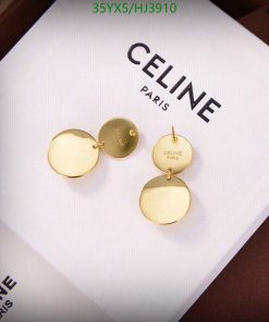 Gold earrings on Celine Paris branded box.