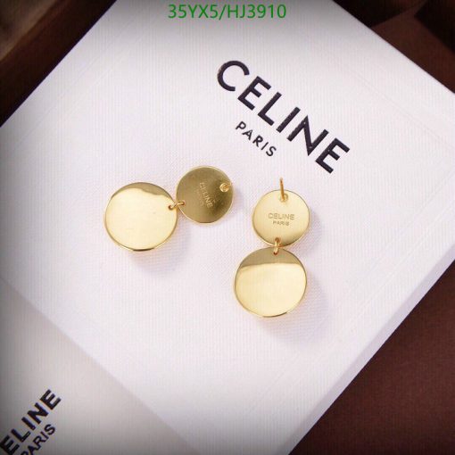 Gold earrings on Celine Paris branded box.