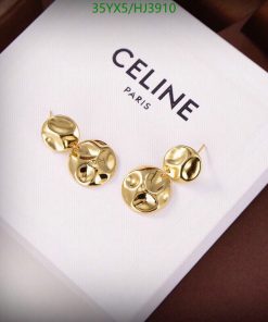 Gold Celine designer earrings on white presentation box.