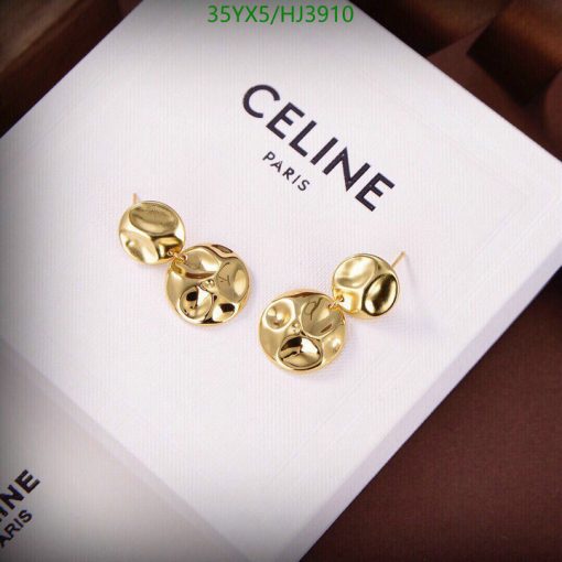 Gold Celine designer earrings on white presentation box.