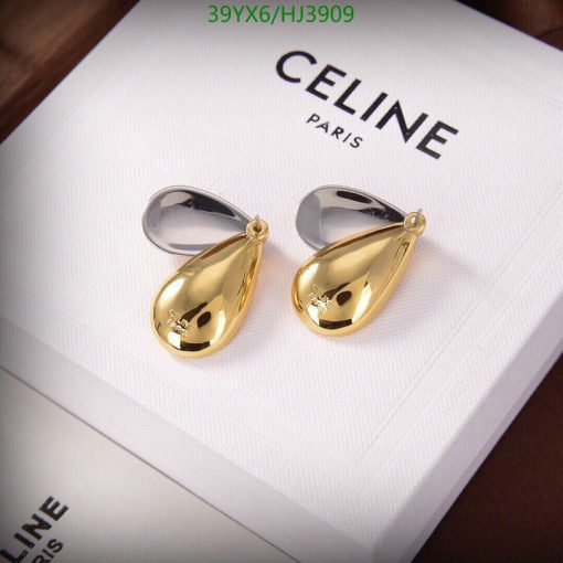 Gold teardrop earrings on white Celine box.