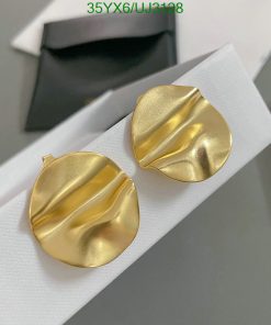 Gold textured earrings on white display.