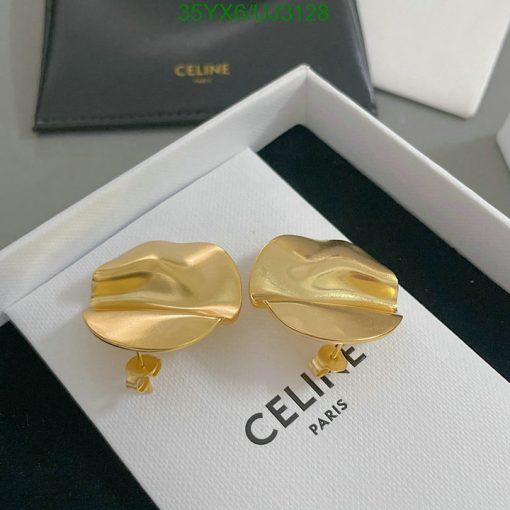 Gold designer lip-shaped earrings on display.