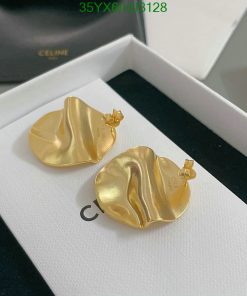 Gold designer earrings in box.