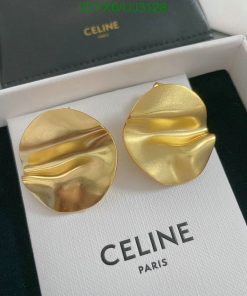 Celine gold wavy earrings on white display box.