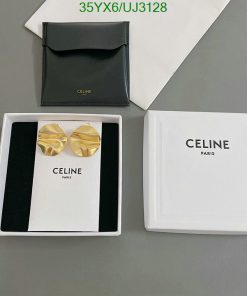 Celine branded earrings and packaging on table.