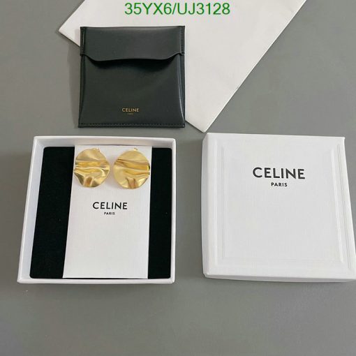 Celine branded earrings and packaging on table.