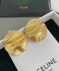 Gold designer earrings on Celine box.