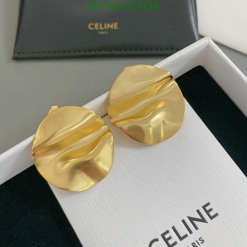 Gold designer earrings on Celine box.