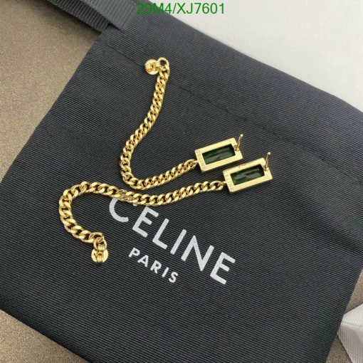 Celine Paris label with gold chain and green earrings.