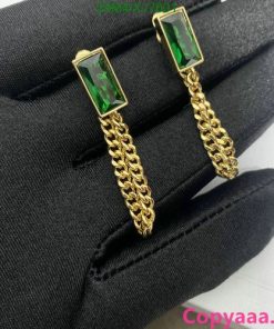 Emerald cufflinks on black fabric.