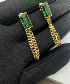 Emerald cufflinks on black fabric.