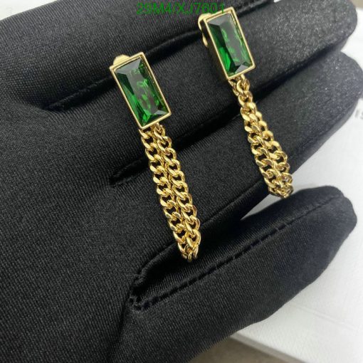 Emerald cufflinks on black fabric.