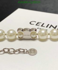 Pearl bracelet with silver clasp and designer logo.