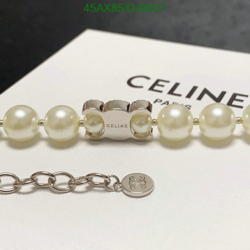 Pearl bracelet with silver clasp and designer logo.