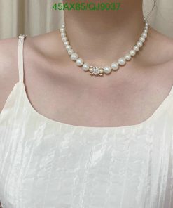 Woman wearing pearl necklace and white dress