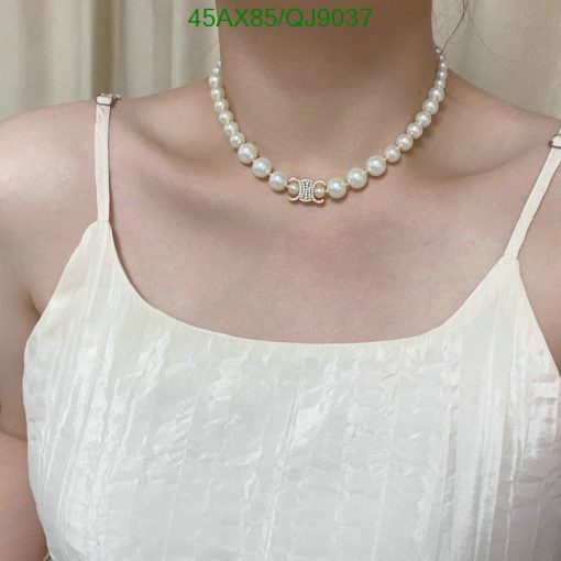 Woman wearing pearl necklace and white dress