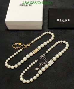 Celine pearl necklaces with box and pouch on black.