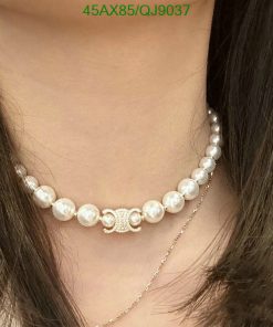 Pearl necklace on woman's neck.