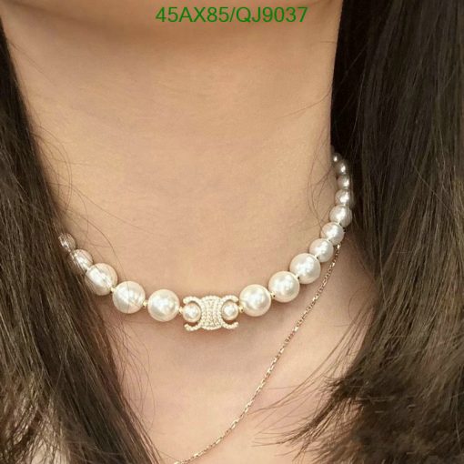 Pearl necklace on woman's neck.