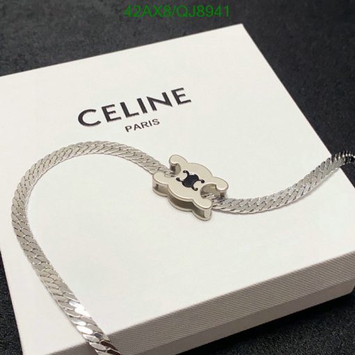 Celine Paris silver bracelet on white box.