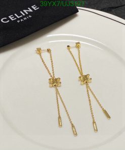 Gold Celine Paris bowtie-shaped drop earrings.