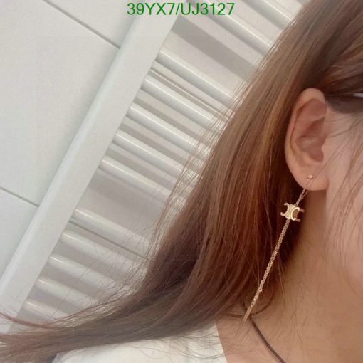 Woman's ear with stylish dangling earring.