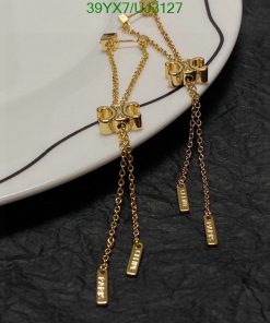 Gold barbell earrings with chain dangles.