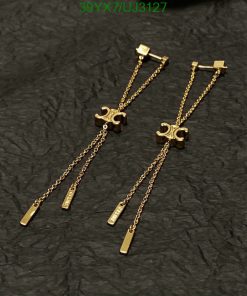 Gold puzzle piece earrings on black background.