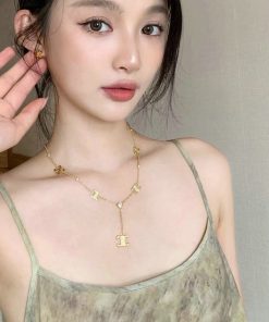 Woman posing with elegant gold necklace jewelry.