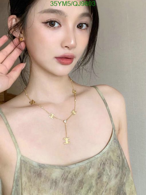 Woman posing with elegant gold necklace jewelry.