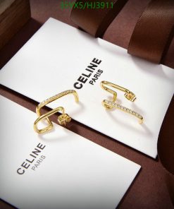 Celine gold earrings on display with brand packaging.