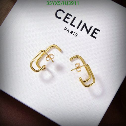 Gold Celine hoop earrings on white display.