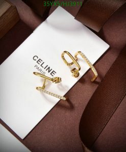 Gold Celine earrings on white card with brown ribbon.