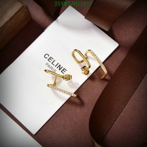 Gold Celine earrings on white card with brown ribbon.