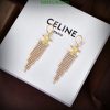 Gold tassel earrings on branded display box