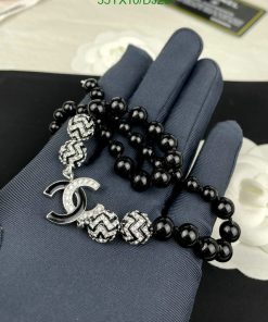 Black beaded bracelet with silver accents displayed on hand.