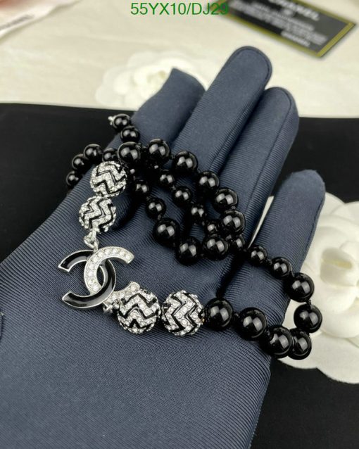 Black beaded bracelet with silver accents displayed on hand.