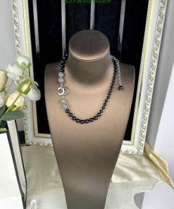 Elegant black bead necklace on mannequin display.