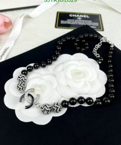 Beaded necklace with white flower pendants and silver accents.