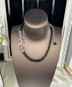 Elegant beaded necklace on mannequin display.